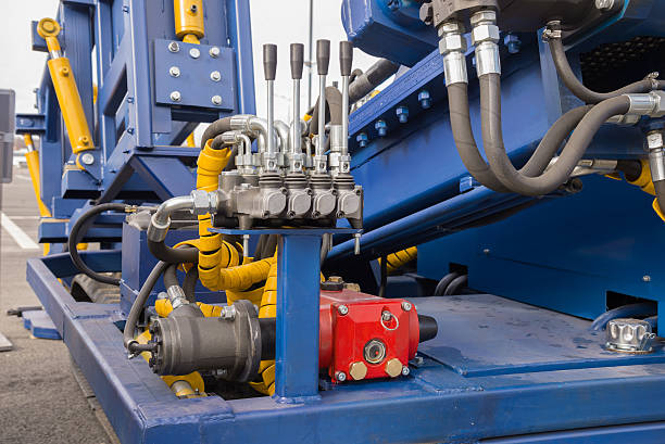 Hydraulic tubes, fittings and levers on control panel of lifting mechanism